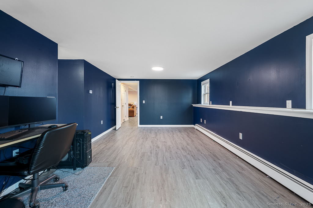 437 Somers Road Ellington, CT 06029 - Photo 23 of 40 a workspace with wooden floor and windows