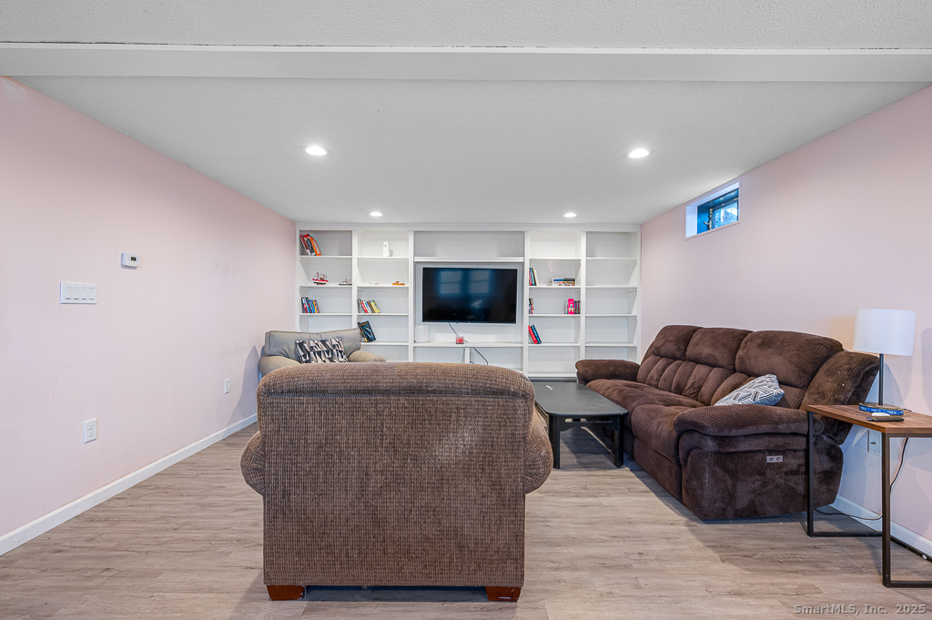 437 Somers Road Ellington, CT 06029 - Photo 24 of 40 a living room with furniture and a flat screen tv