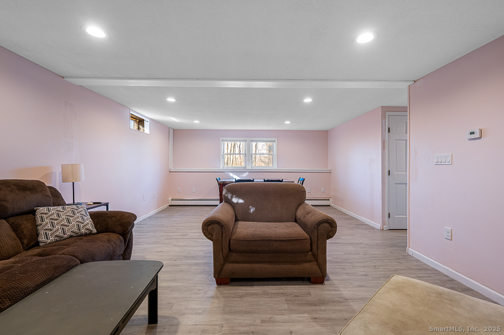 437 Somers Road Ellington, CT 06029 - Photo 25 of 40 a living room with furniture and a couch