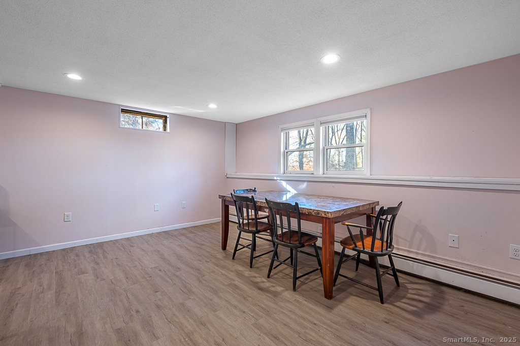 437 Somers Road Ellington, CT 06029 - Photo 26 of 40 a view of a dining room with furniture and wooden floor