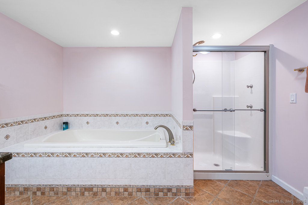 437 Somers Road Ellington, CT 06029 - Photo 29 of 40 a bathroom with a tub and a shower
