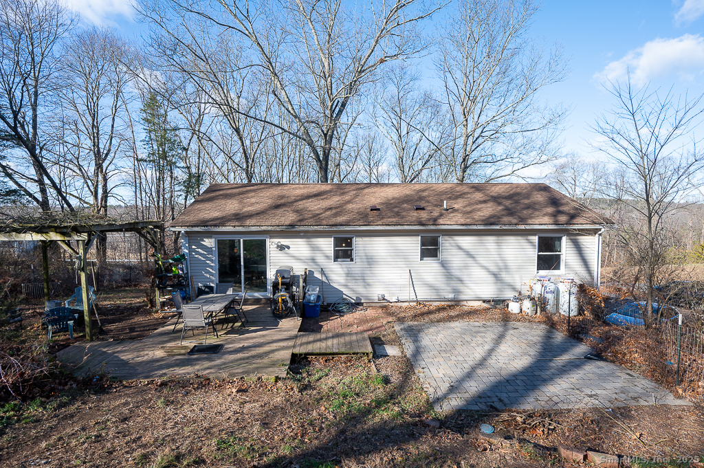 437 Somers Road Ellington, CT 06029 - Photo 33 of 40 a backyard of a house with barbeque oven fire pit table and chairs