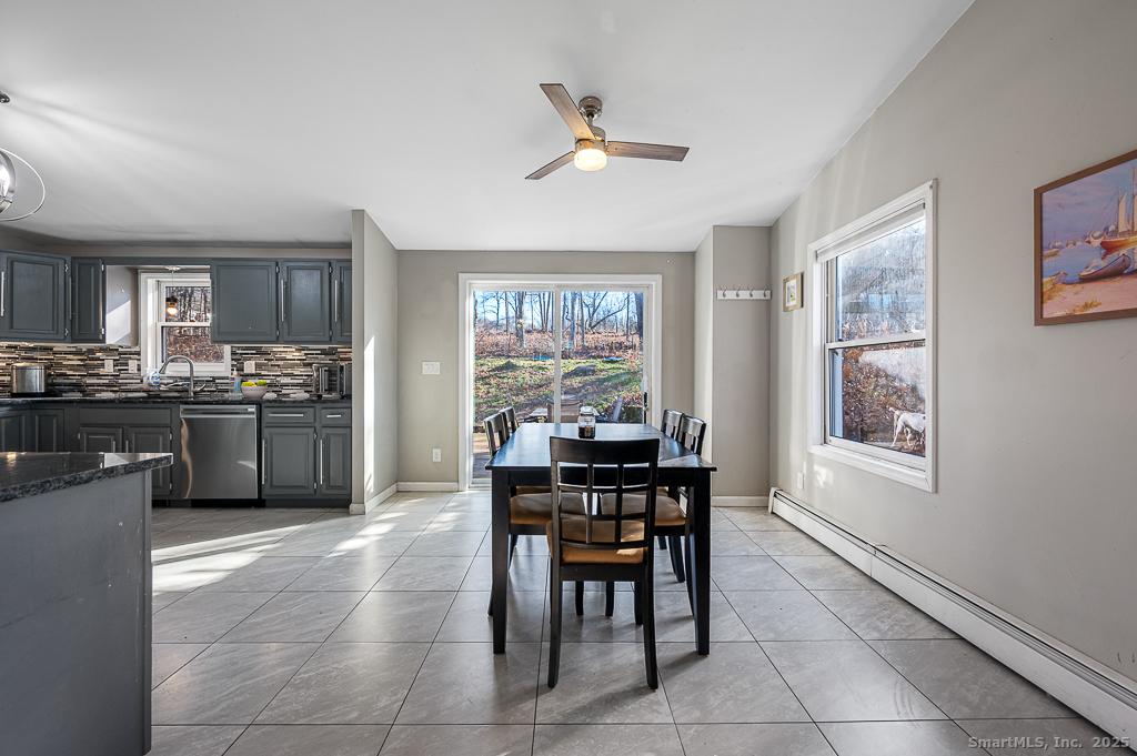 437 Somers Road Ellington, CT 06029 - Photo 7 of 40 a kitchen with a table and chairs in it