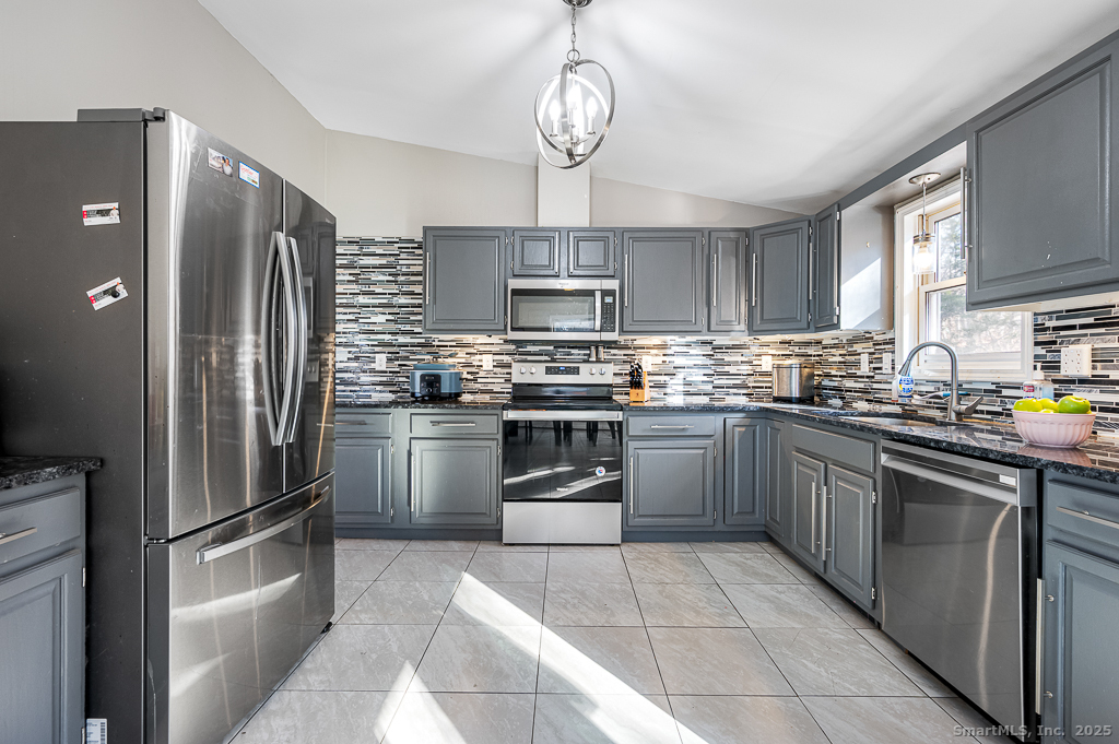 437 Somers Road Ellington, CT 06029 - Photo 9 of 40 a kitchen with a refrigerator sink and oven