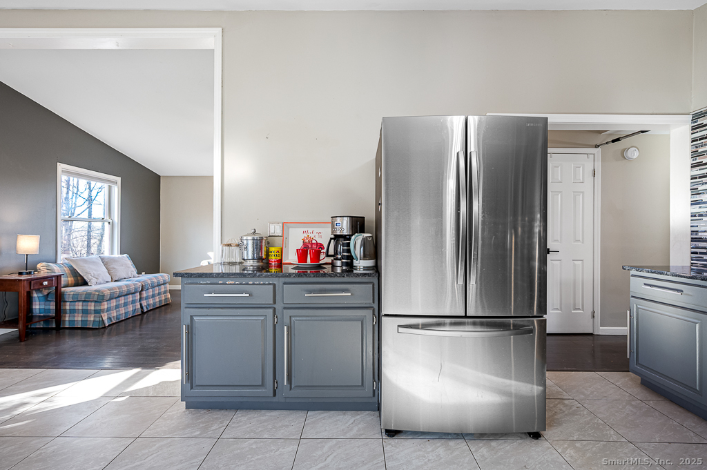 437 Somers Road Ellington, CT 06029 - Photo 10 of 40 a kitchen with a refrigerator and furniture