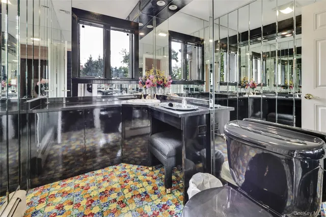 a large bedroom with a bed and a large window