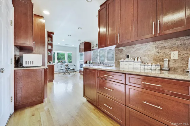 a view of a dining room with furniture a chandelier and wooden floor