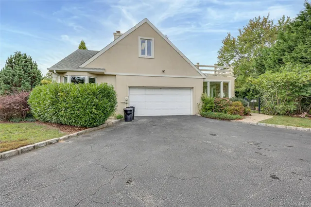 a front view of a house with a yard and a garage