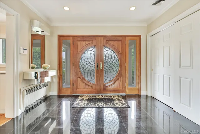a view of an entryway with wooden floor