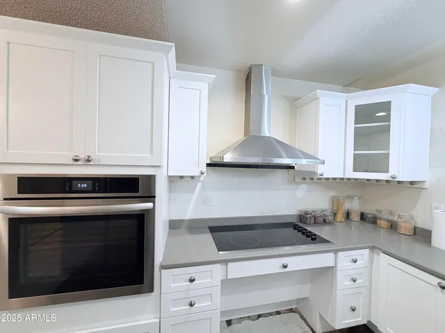 a bathroom with a granite countertop sink toilet and mirror