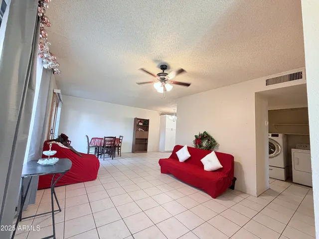 a bedroom with furniture and a chandelier fan