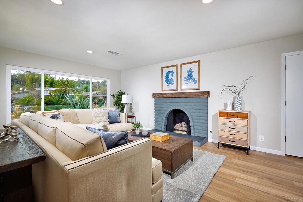 341 Cole Ranch Road Encinitas, CA 92024 - Photo 17 of 44 a living room with furniture a fireplace and a floor to ceiling window