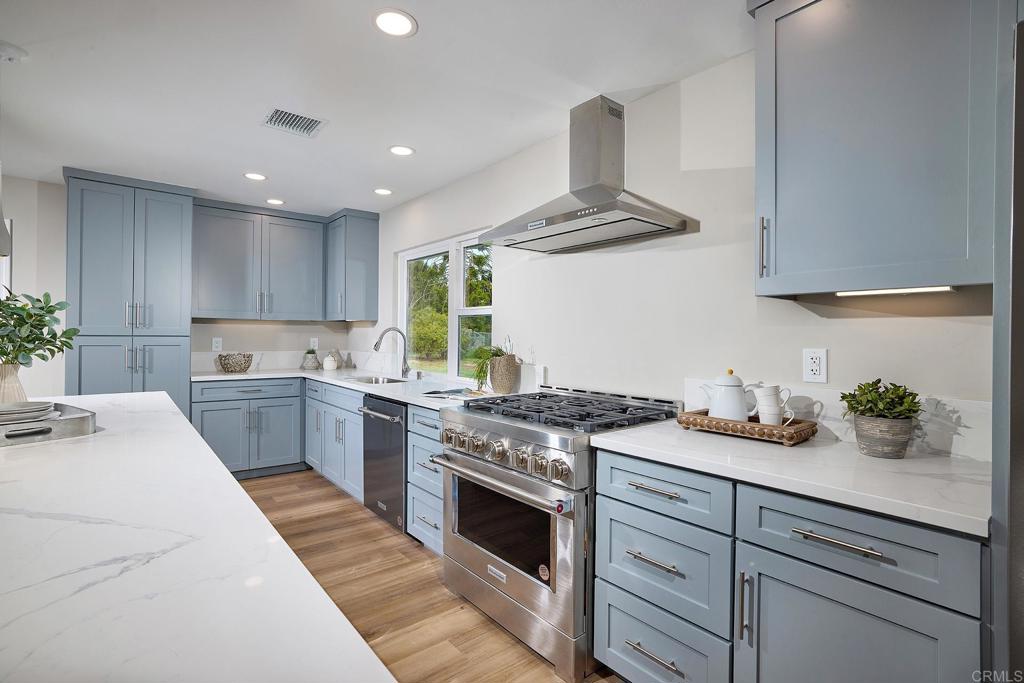 341 Cole Ranch Road Encinitas, CA 92024 - Photo 20 of 44 a kitchen with stainless steel appliances granite countertop a sink stove and cabinets
