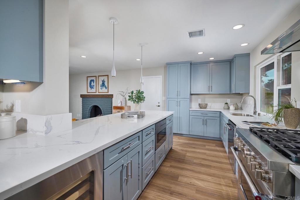 341 Cole Ranch Road Encinitas, CA 92024 - Photo 21 of 44 a kitchen with kitchen island stainless steel appliances a sink stove and cabinets
