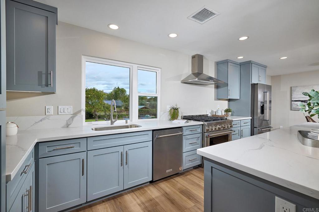 341 Cole Ranch Road Encinitas, CA 92024 - Photo 22 of 44 a kitchen with white cabinets and appliances
