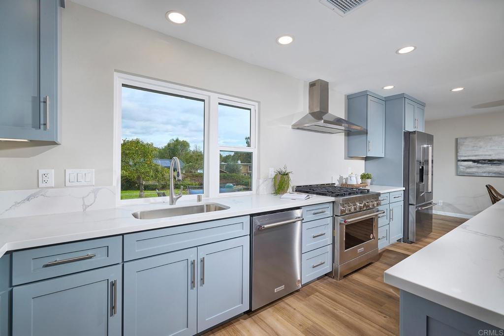 341 Cole Ranch Road Encinitas, CA 92024 - Photo 23 of 44 a kitchen with kitchen island granite countertop a sink stainless steel appliances and cabinets