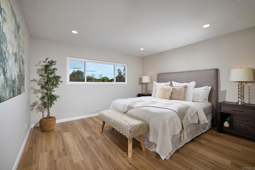 341 Cole Ranch Road Encinitas, CA 92024 - Photo 24 of 44 a bedroom with bed and a potted plant