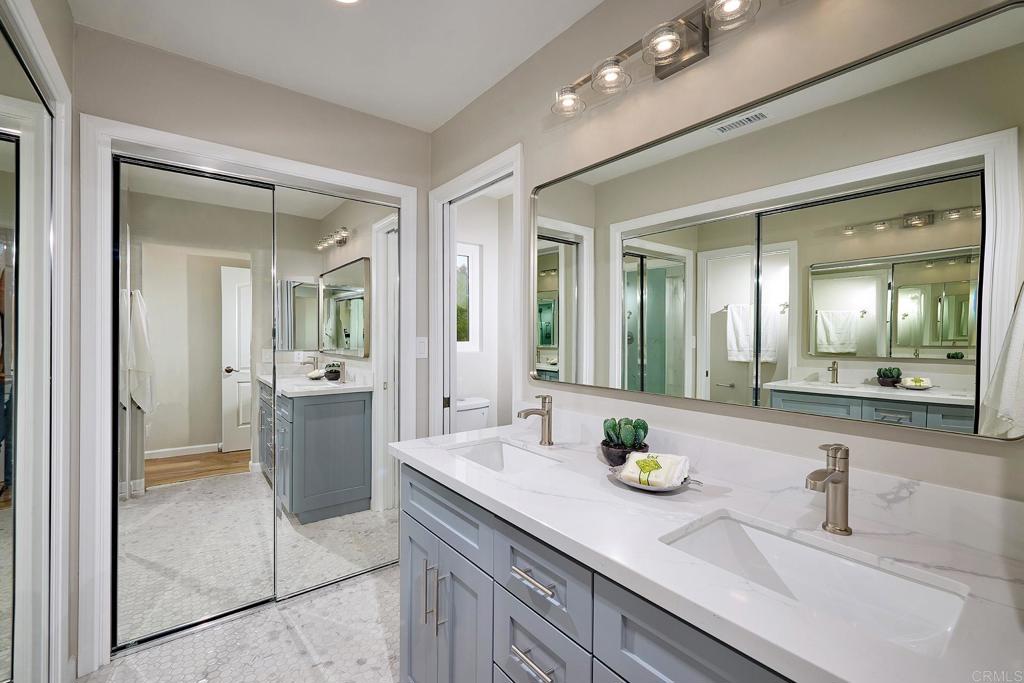 341 Cole Ranch Road Encinitas, CA 92024 - Photo 25 of 44 a bathroom with a granite countertop sink a toilet and a mirror