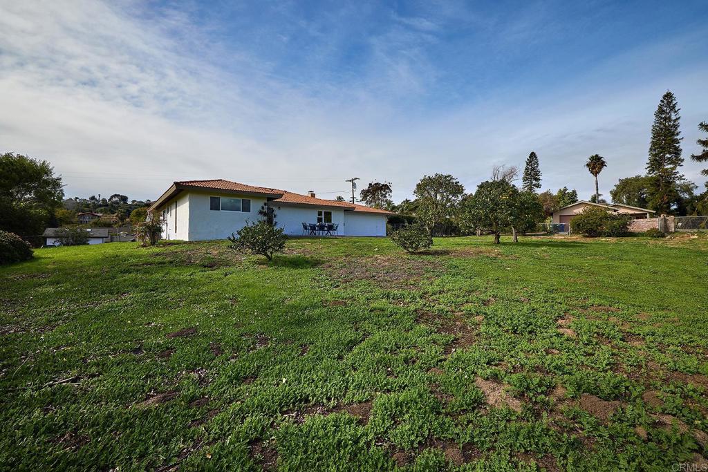 341 Cole Ranch Road Encinitas, CA 92024 - Photo 35 of 44 a backyard of a house with table and chairs a barbeque