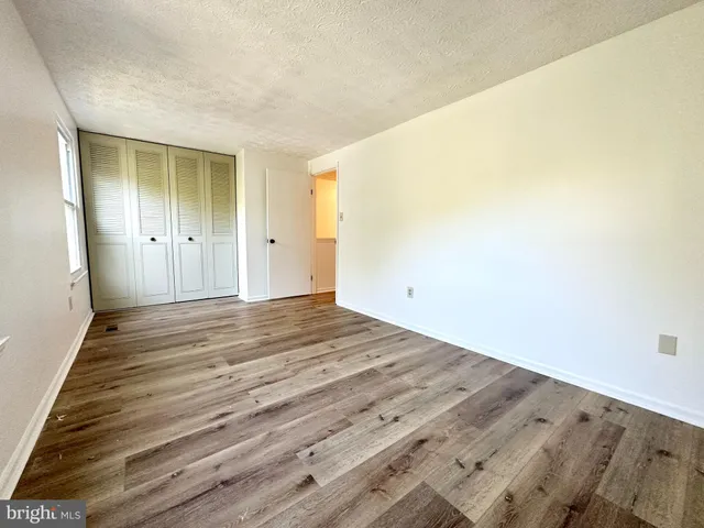 a view of a room with wooden floor and brick wall