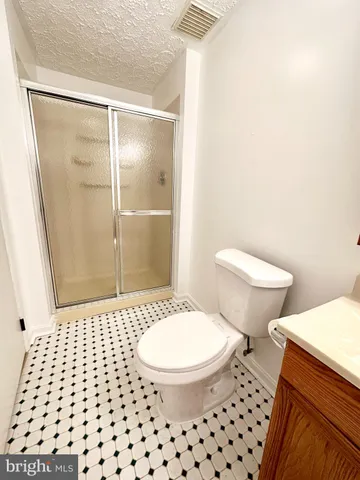 a bathroom with a toilet a sink and a shower
