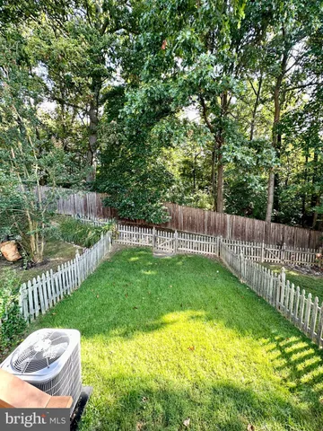 a view of a backyard with wooden fence