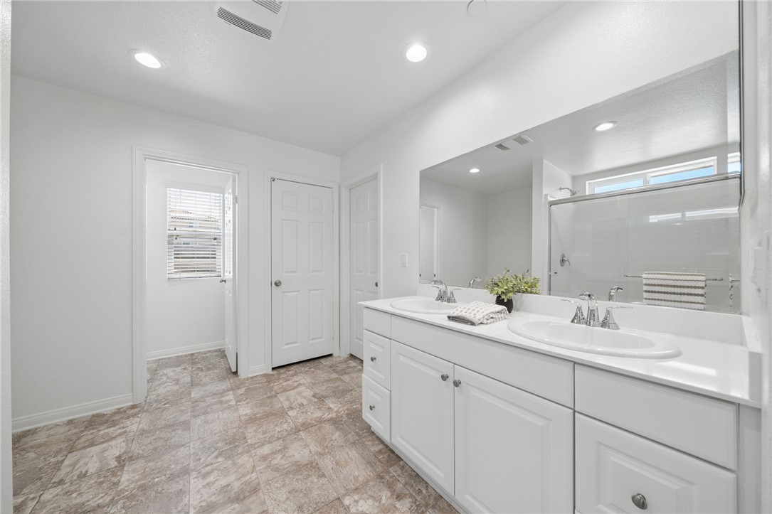 20130 Curaco Court Riverside, CA 92507 - Photo 25 of 43 Dual-sink vanity with a large wall mirror and ample storage.