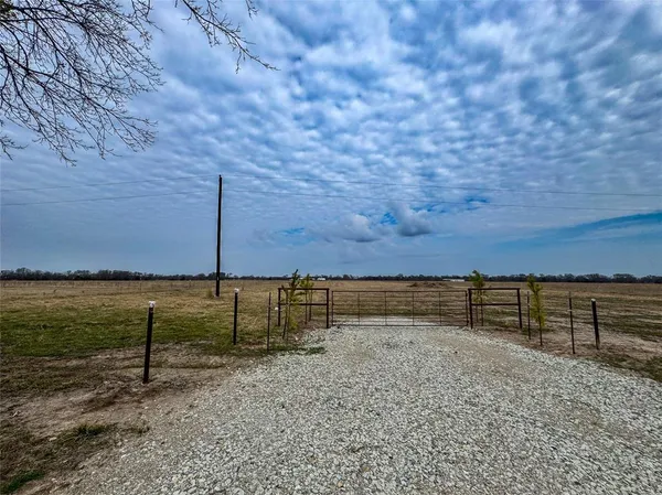 a view of a yard with a fence