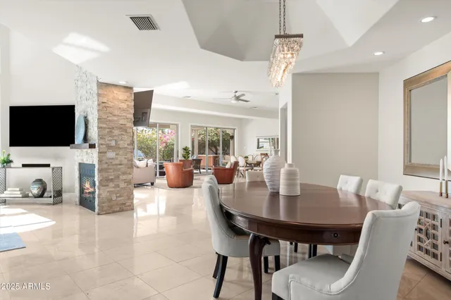 a bedroom with a bed a large window and a flat screen tv
