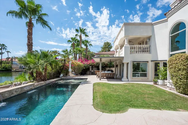an aerial view of a house with a lake