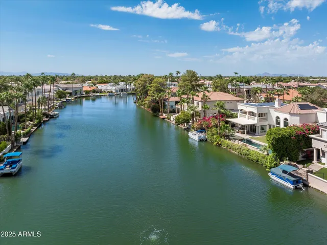 an aerial view of residential houses with outdoor space and swimming pool