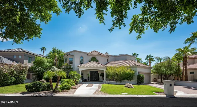 a view of house with yard and tree in the background