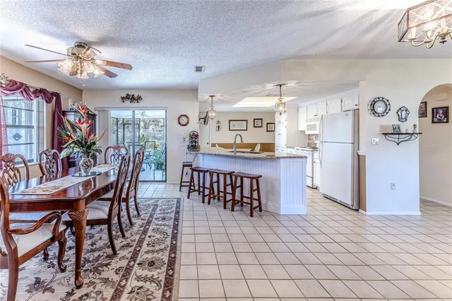 a kitchen with cabinets and chairs