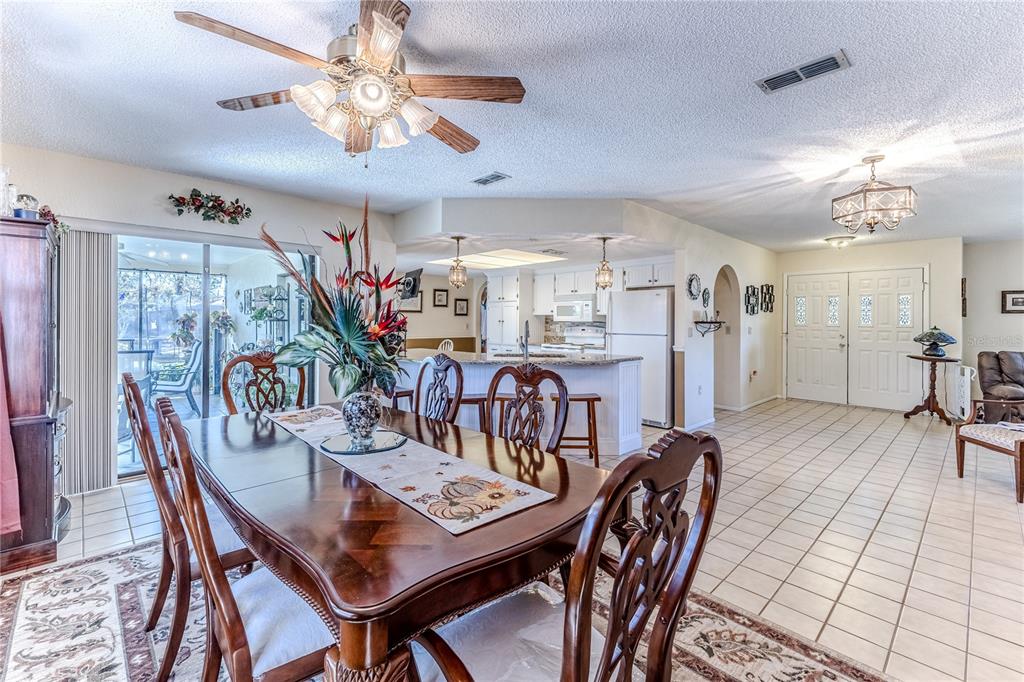 11249 Riddle Drive Spring Hill, FL 34609 - Photo 12 of 43 a dining room with furniture entryway and wooden floor