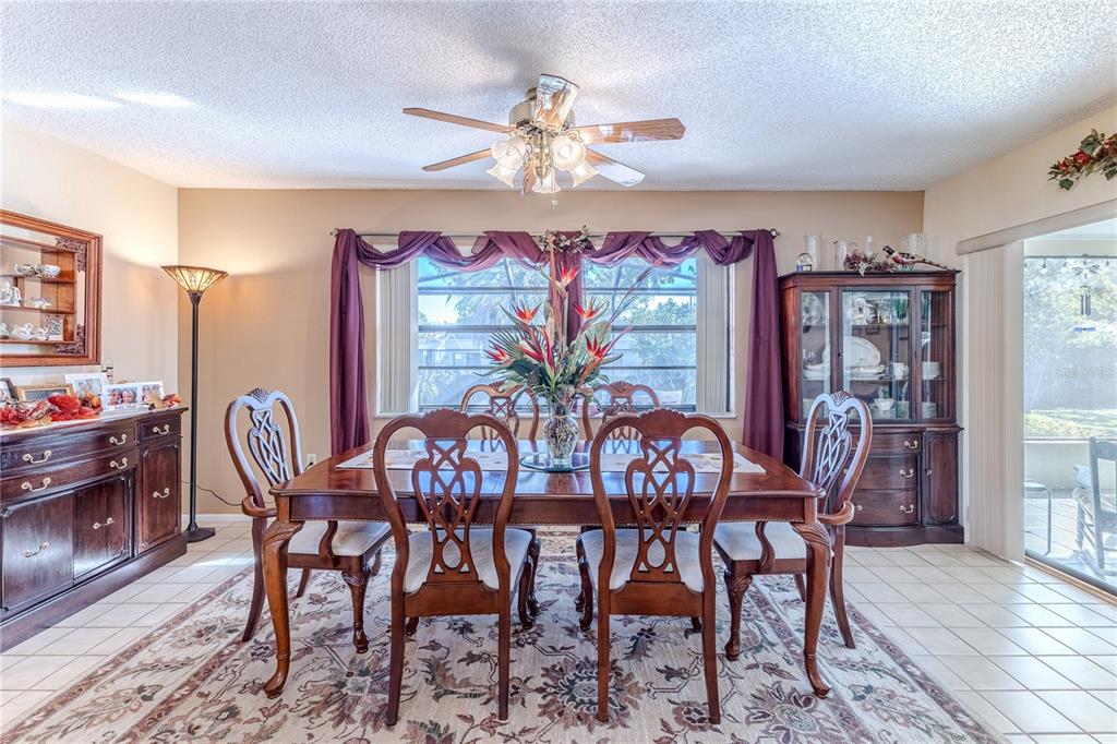 11249 Riddle Drive Spring Hill, FL 34609 - Photo 13 of 43 a view of a dining room with furniture window and wooden floor