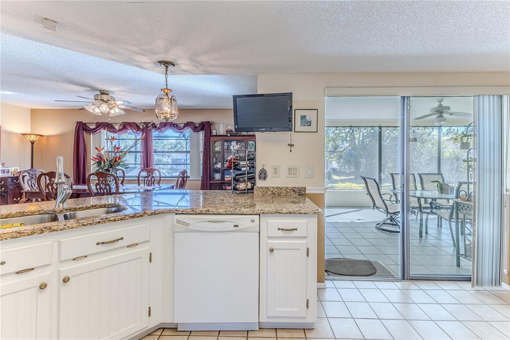 11249 Riddle Drive Spring Hill, FL 34609 - Photo 16 of 43 a kitchen with cabinets and chairs