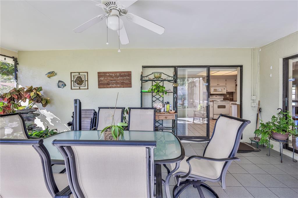 11249 Riddle Drive Spring Hill, FL 34609 - Photo 35 of 43 a dining room with furniture potted plants and wooden floor