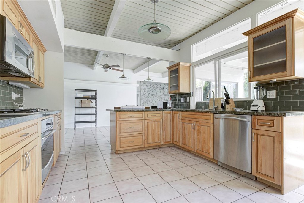 10412 Reseda Boulevard Porter Ranch, CA 91326 - Photo 10 of 38 a kitchen with cabinets and window