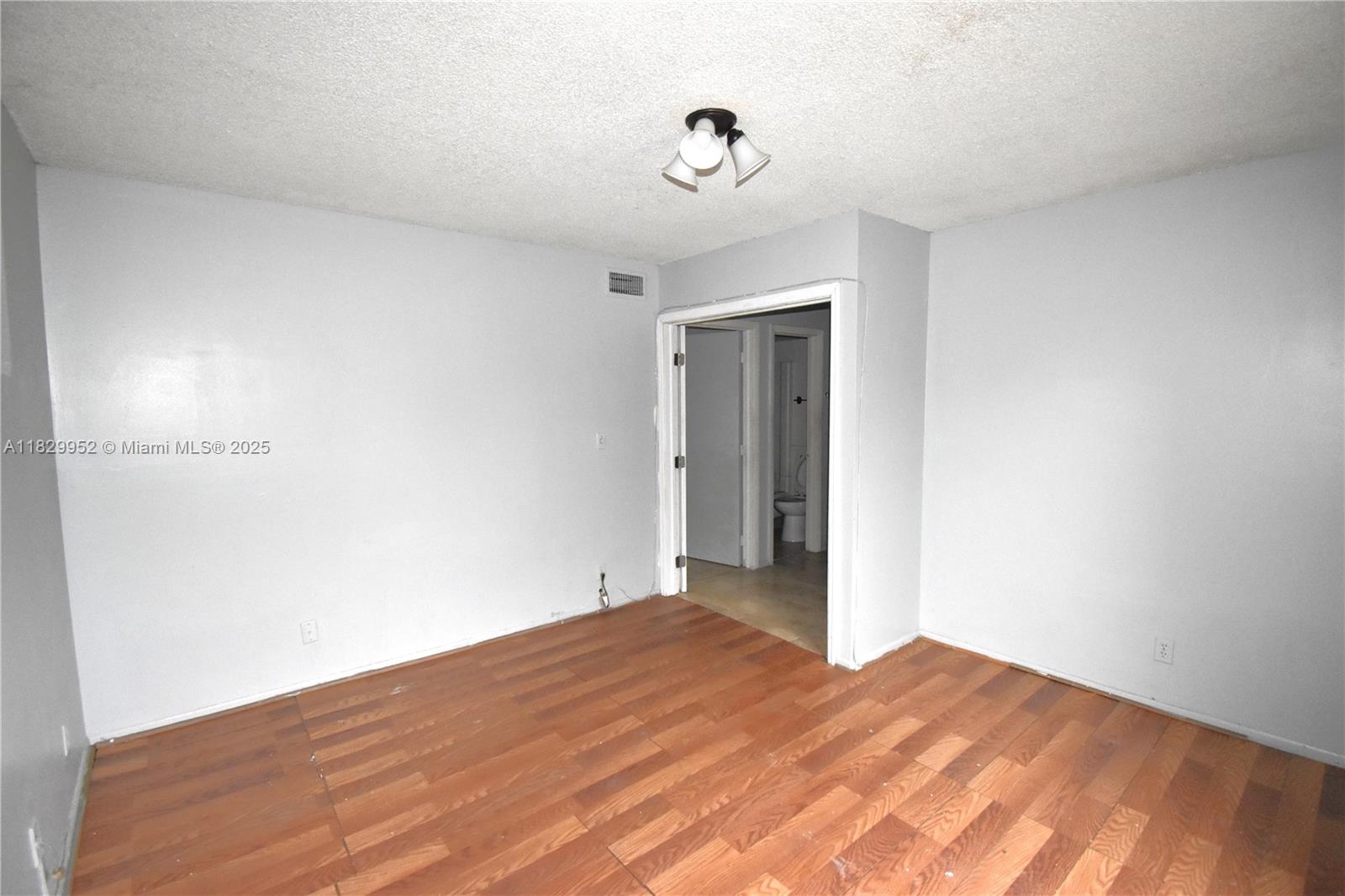 4231 Northwest 19th Street, Unit 256 Lauderhill, FL 33313 - Photo 11 of 16 a view of a room with wooden floor and a ceiling fan