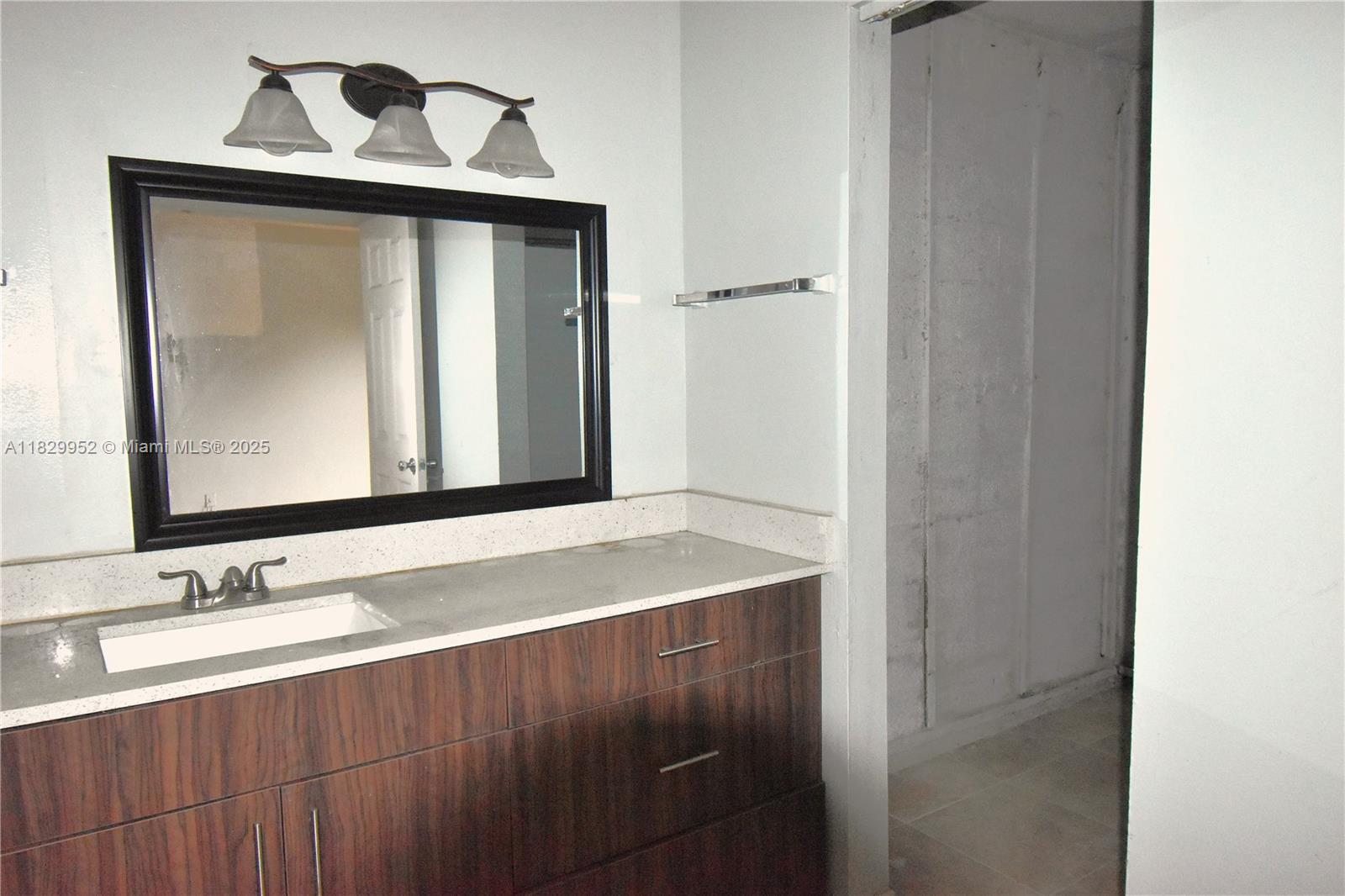 4231 Northwest 19th Street, Unit 256 Lauderhill, FL 33313 - Photo 13 of 16 a bathroom with a sink and a mirror