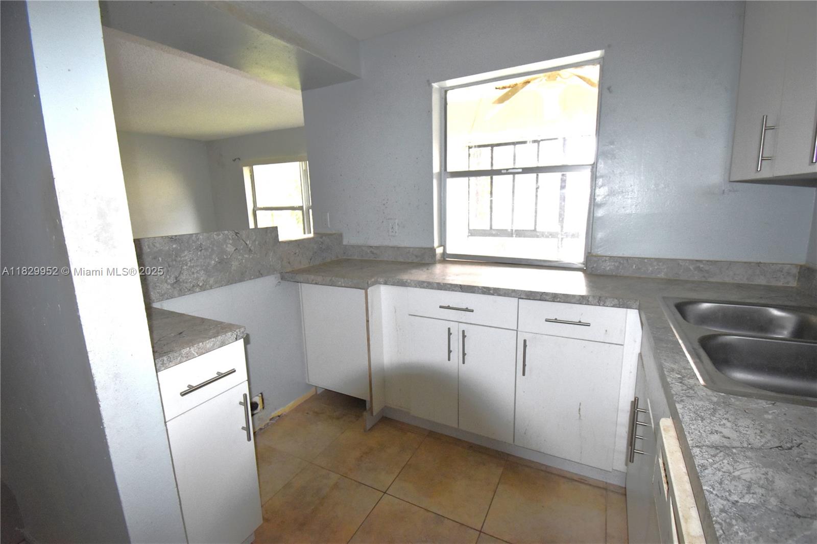 4231 Northwest 19th Street, Unit 256 Lauderhill, FL 33313 - Photo 3 of 16 a kitchen with white cabinets and white appliances
