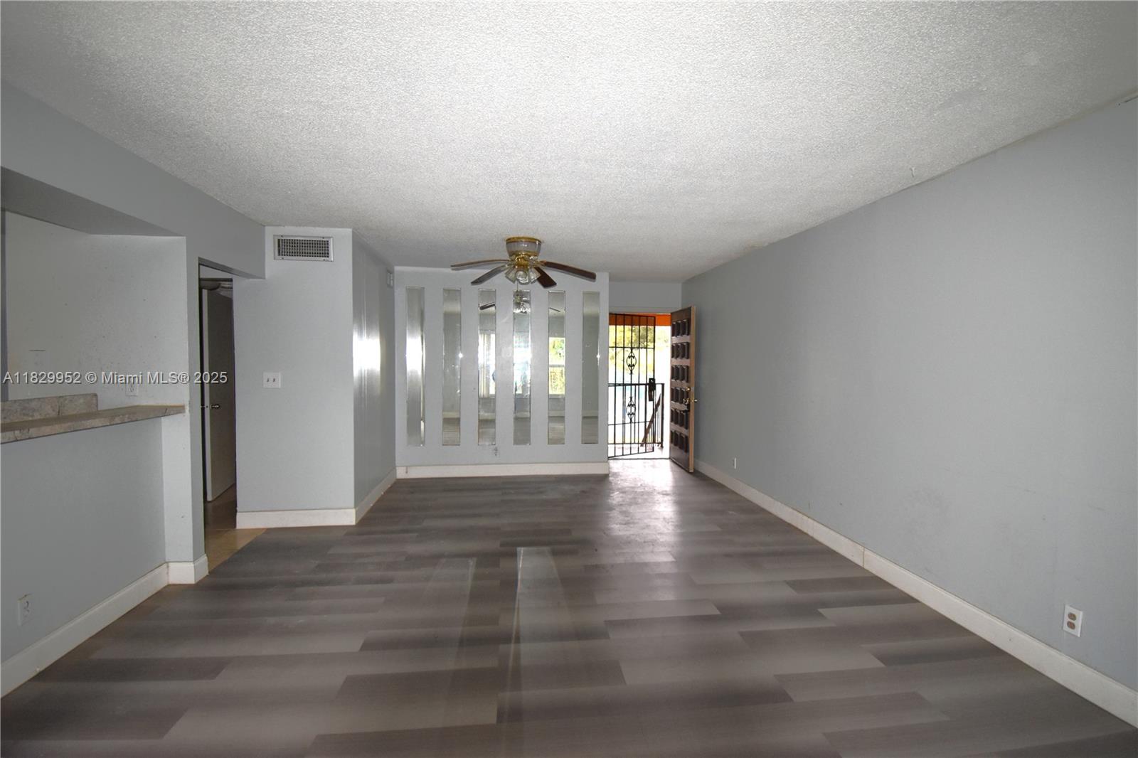 4231 Northwest 19th Street, Unit 256 Lauderhill, FL 33313 - Photo 8 of 16 a view of an empty room with wooden floor and a window