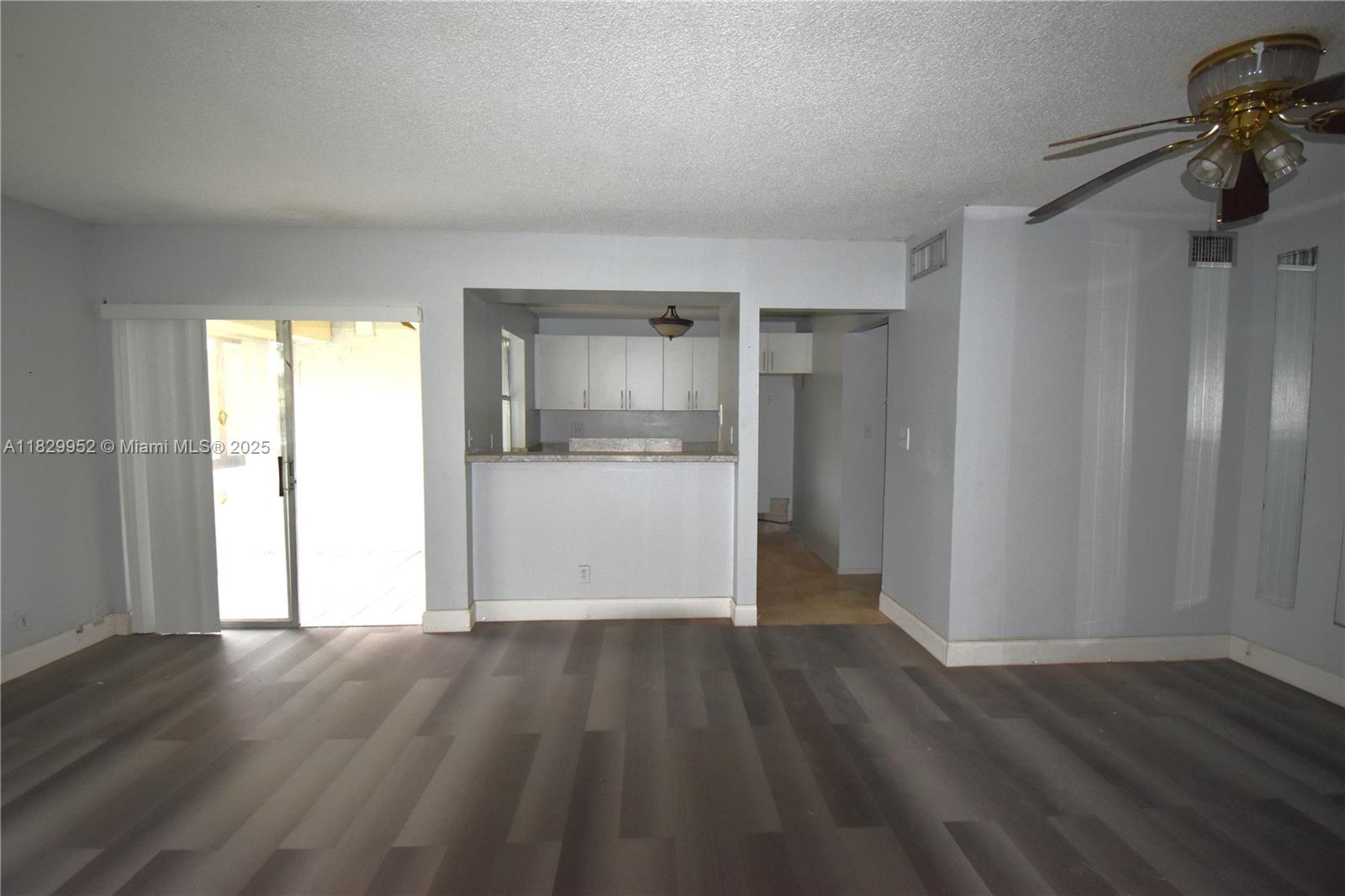 4231 Northwest 19th Street, Unit 256 Lauderhill, FL 33313 - Photo 9 of 16 an empty room with wooden floor and a window