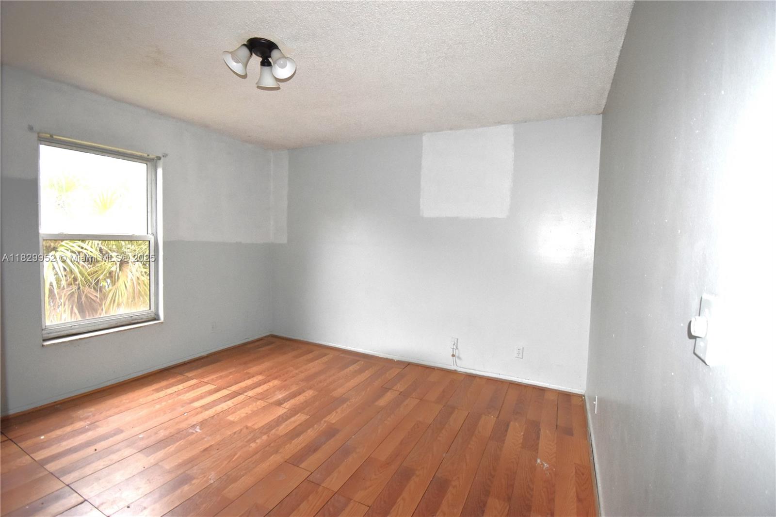 4231 Northwest 19th Street, Unit 256 Lauderhill, FL 33313 - Photo 10 of 16 an empty room with wooden floor and windows
