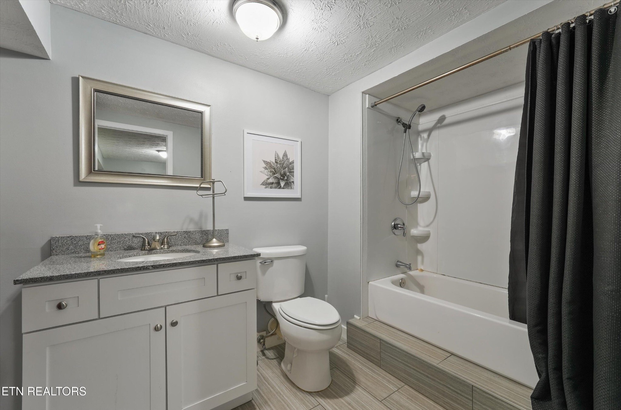 7613 Fall Wind Court Powell, TN 37849 - Photo 28 of 38 a bathroom with a granite countertop toilet sink and mirror