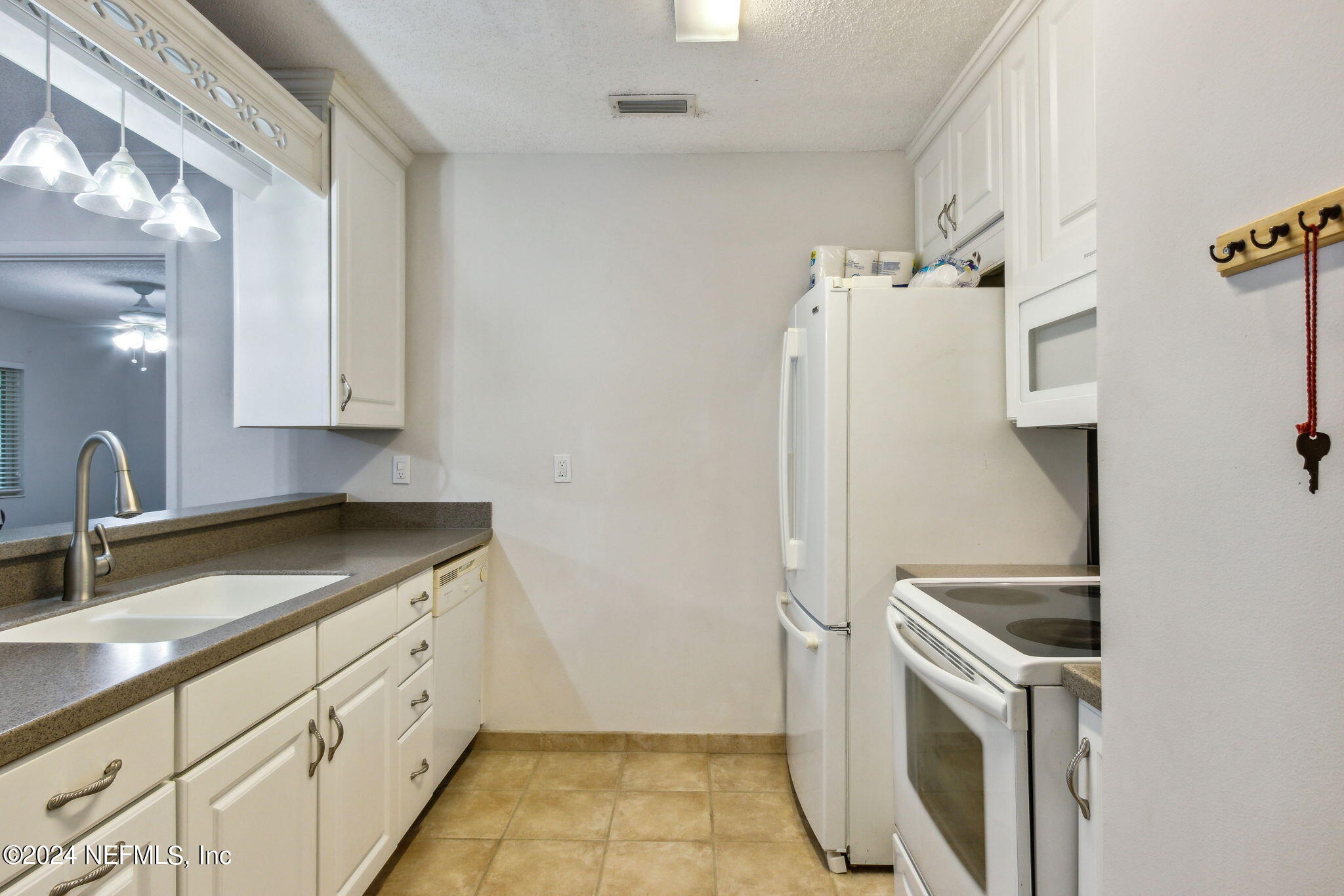 1213 The Grove Road Orange Park, FL 32073 - Photo 14 of 40 a kitchen with a sink stove and refrigerator