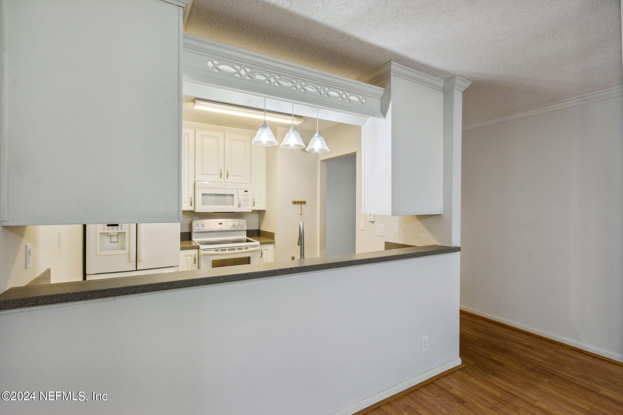 1213 The Grove Road Orange Park, FL 32073 - Photo 15 of 40 a view of a kitchen with wooden floor and a window