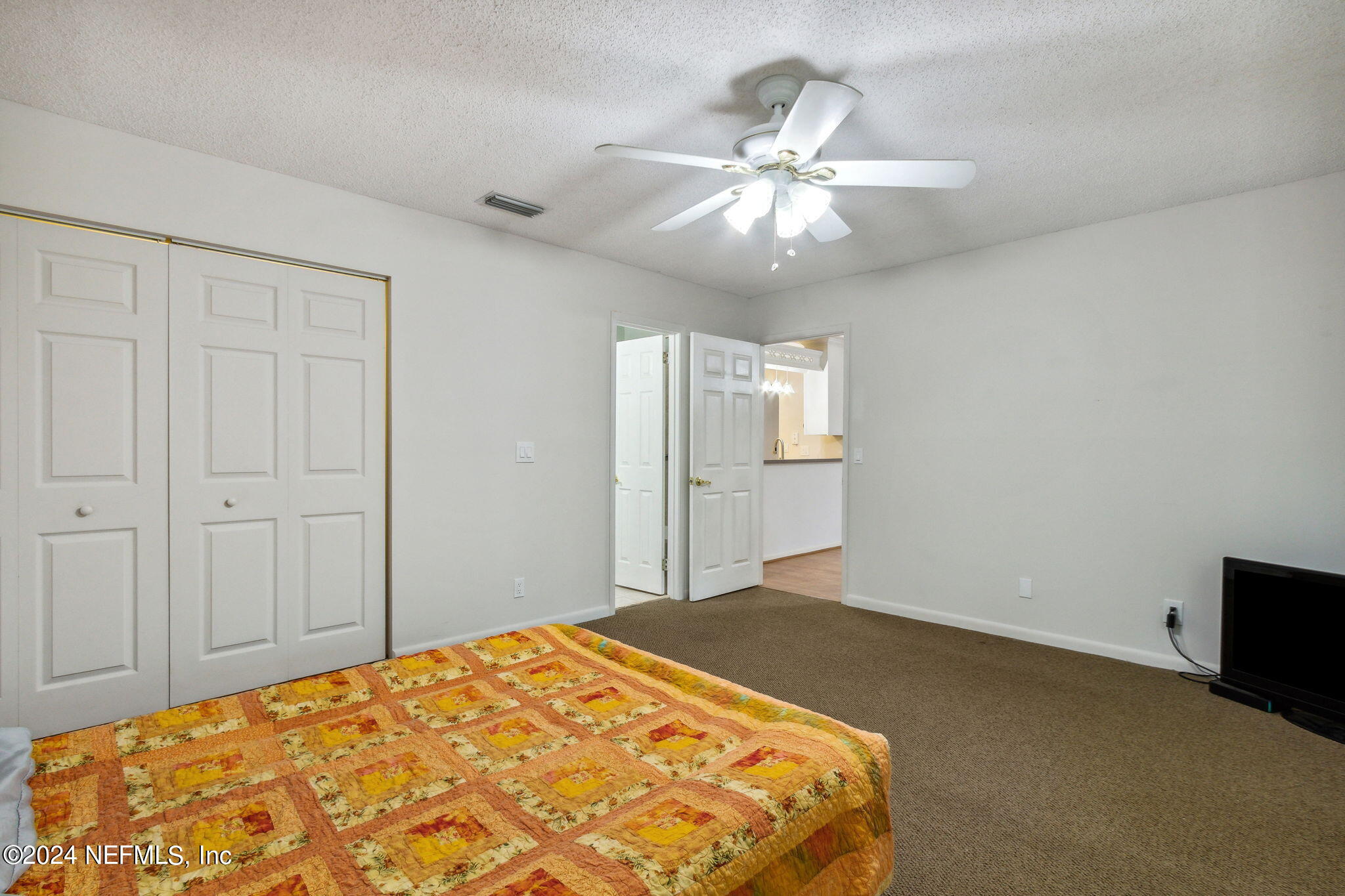 1213 The Grove Road Orange Park, FL 32073 - Photo 28 of 40 a bedroom with a bed and a chandelier