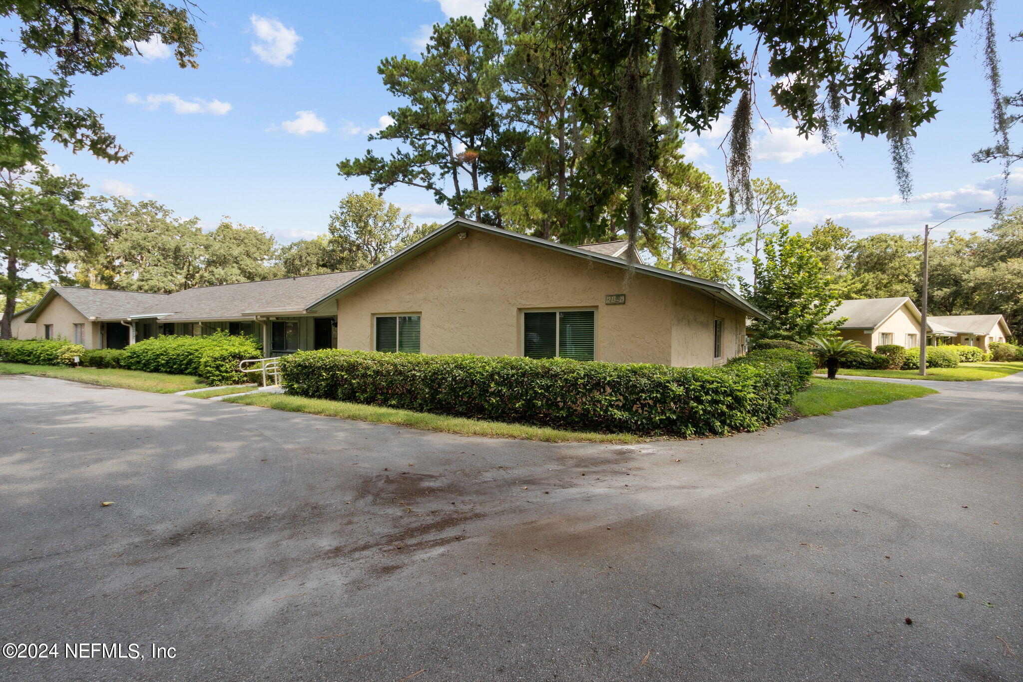 1213 The Grove Road Orange Park, FL 32073 - Photo 37 of 40 a yellow house with trees in front of it