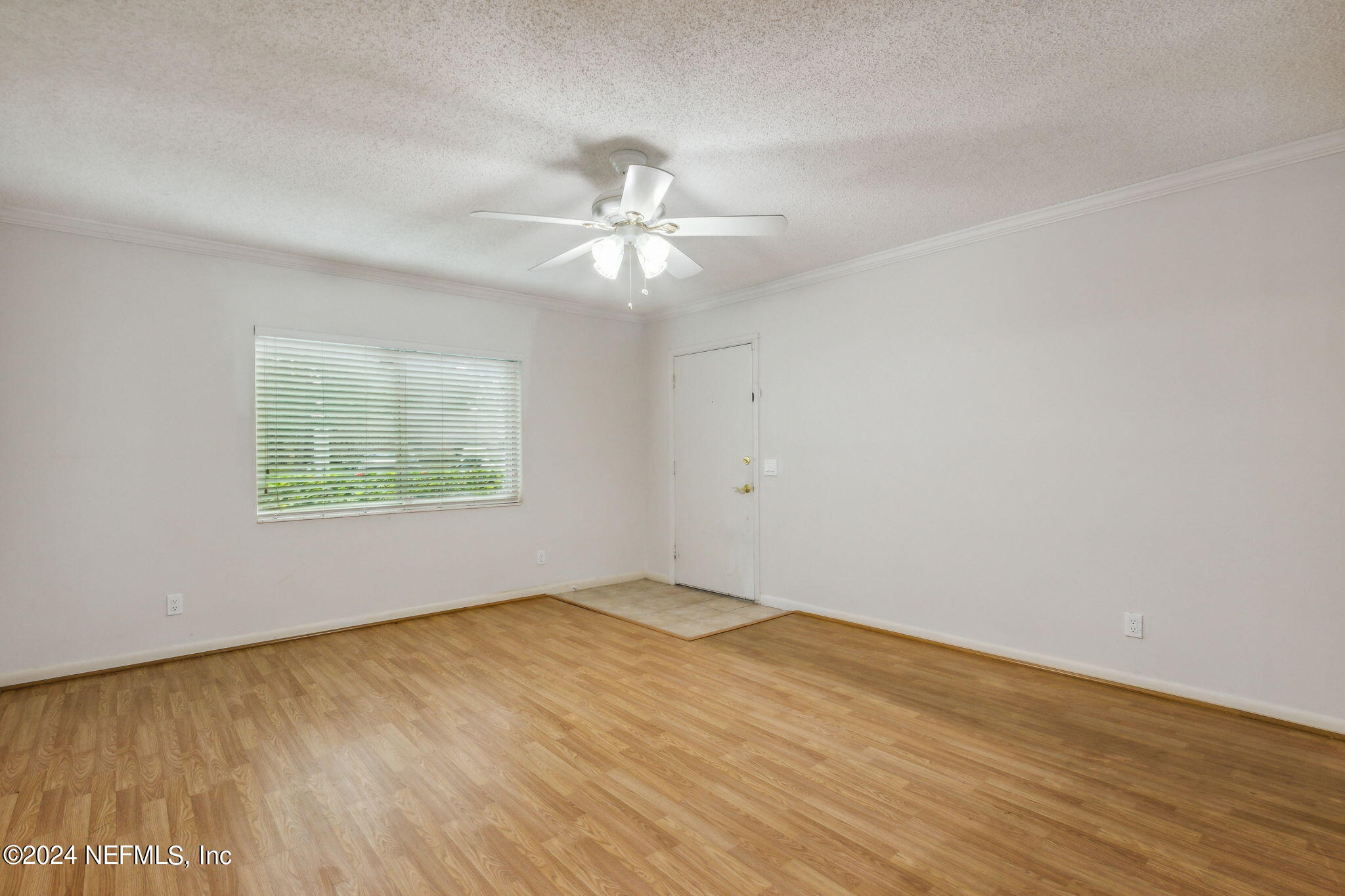 1213 The Grove Road Orange Park, FL 32073 - Photo 10 of 40 wooden floor in an empty room with a window